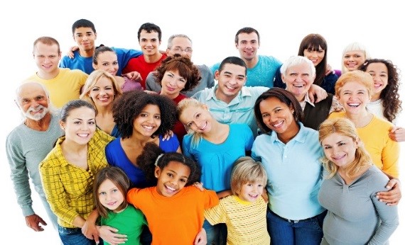 Large group of diverse people wearing bright clothing standing in a close circle