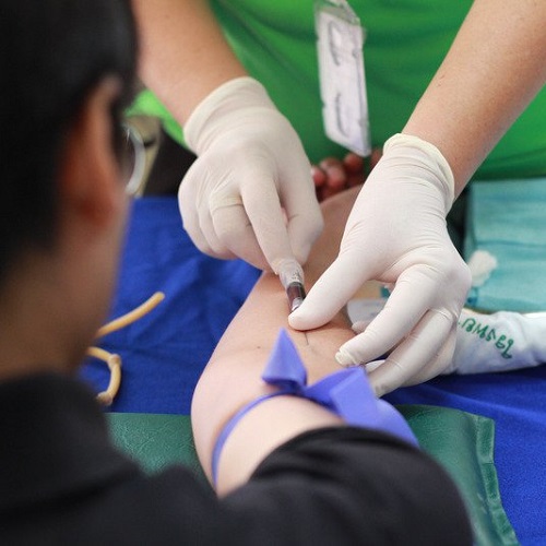 Closeup of a patient getting a blood draw from a nurse